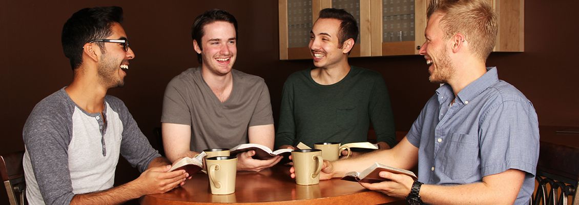 Men sitting at a table talking